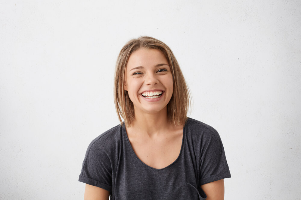 joyful, young woman posing and smiling for a picture